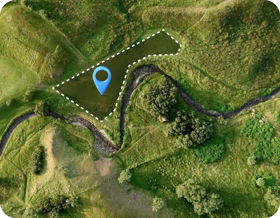 Aerial green land plot with a map marker